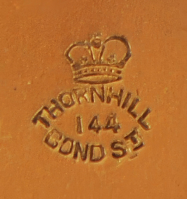 Walter Thornhill manufacturer/retailer stamp on the underside of a silver-gilt vanity jar lid.